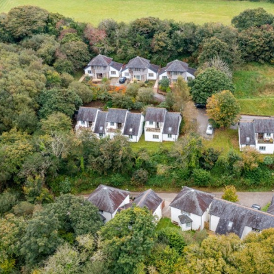 Aerial view of the cottages nestled in woodlands at the valley