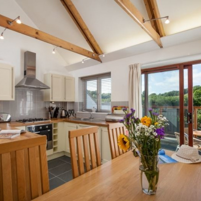 Kitchen, dining and view to balcony