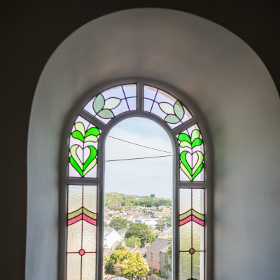 Stained glass window with dune views from bed